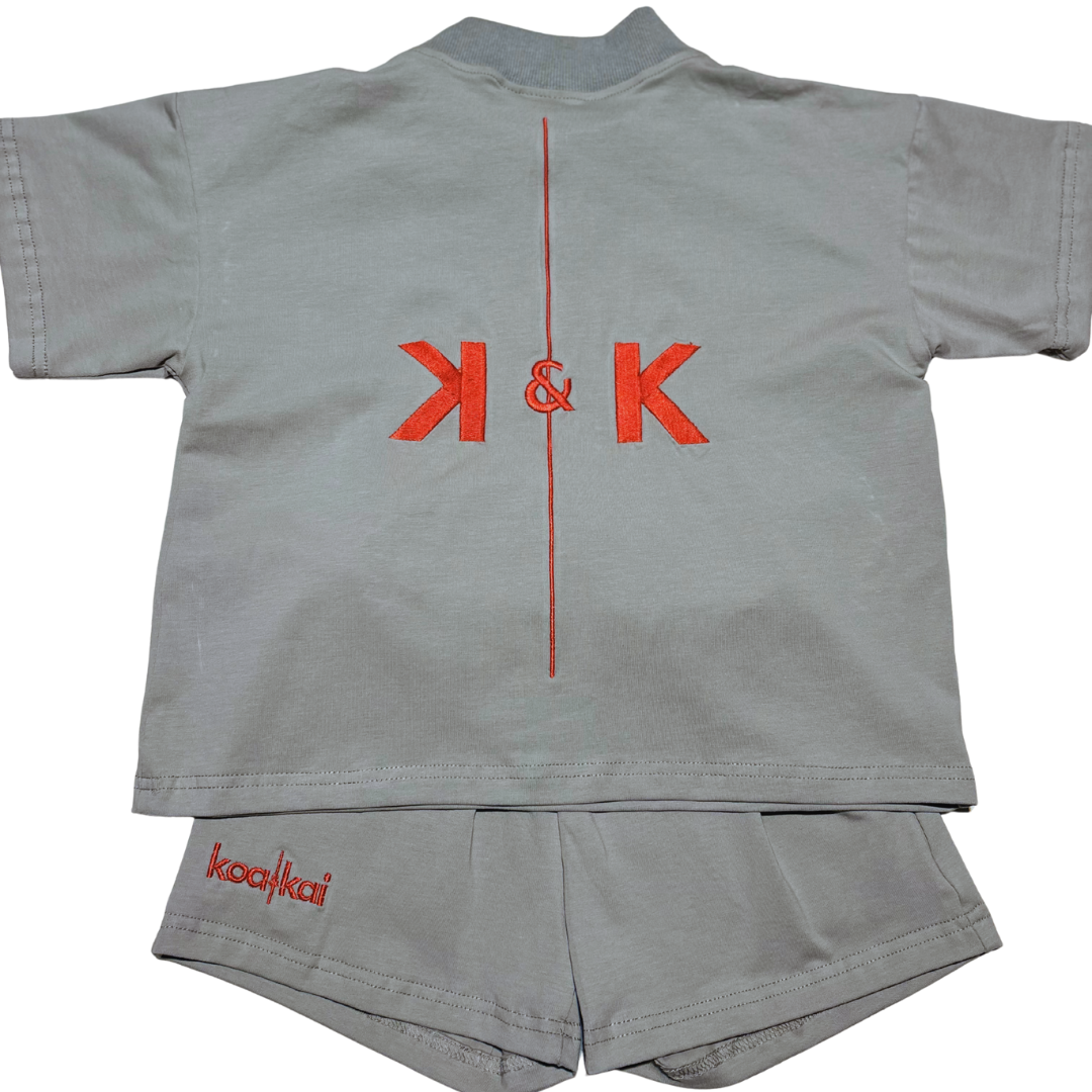 Gray children's shirt and shorts set with red logo on a white background