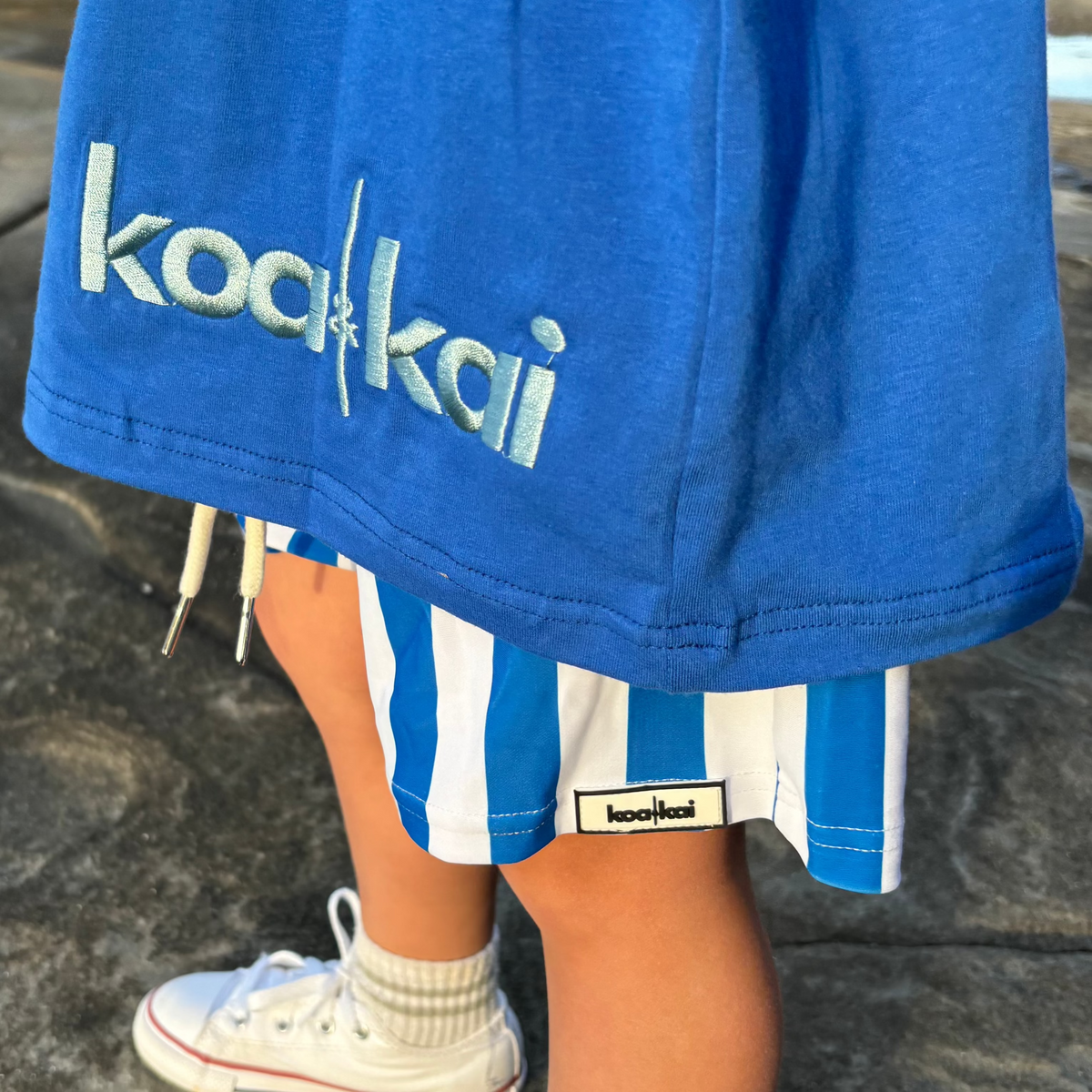 blue and white koa and kai stripe boardshorts close up