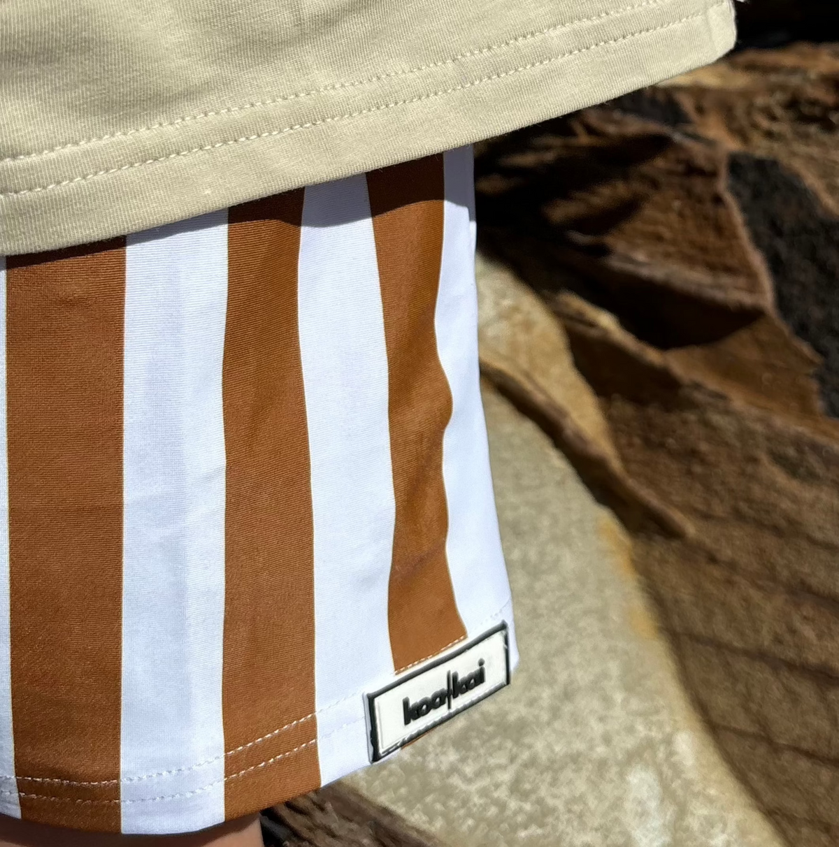 brown and white stripe boardies close up