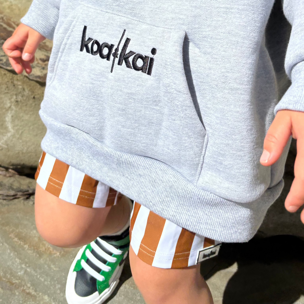 brown and white stripe boardies whith grey jumper koah 