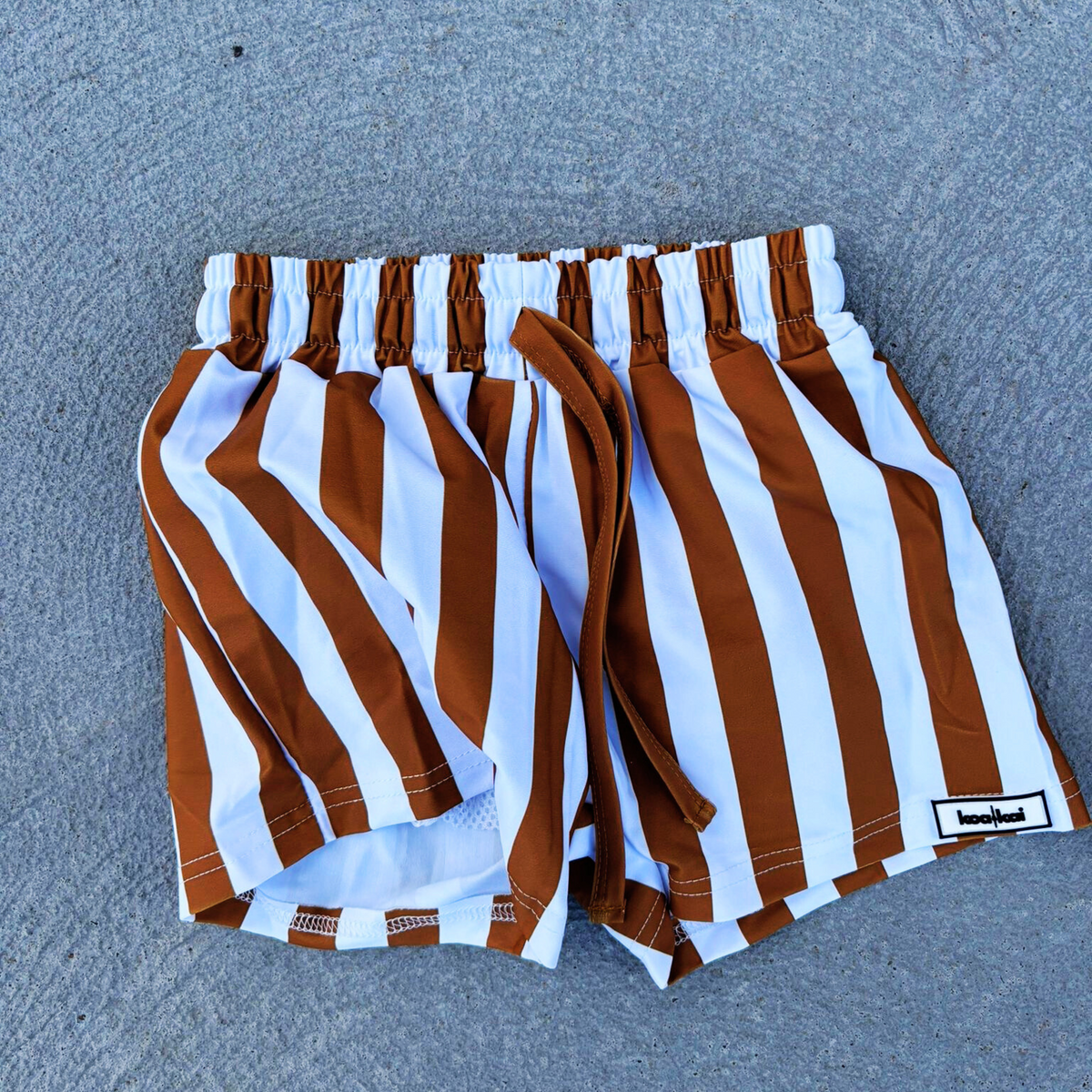 koa and kai driveway flat lay brown stripe boardies
