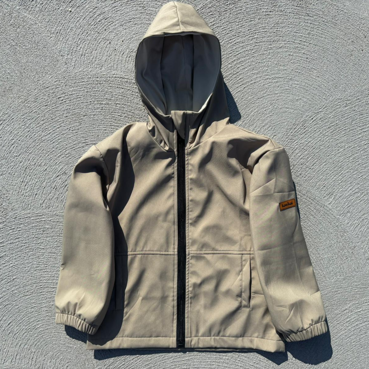 koa and kai earthy tan windbreaker flat lay